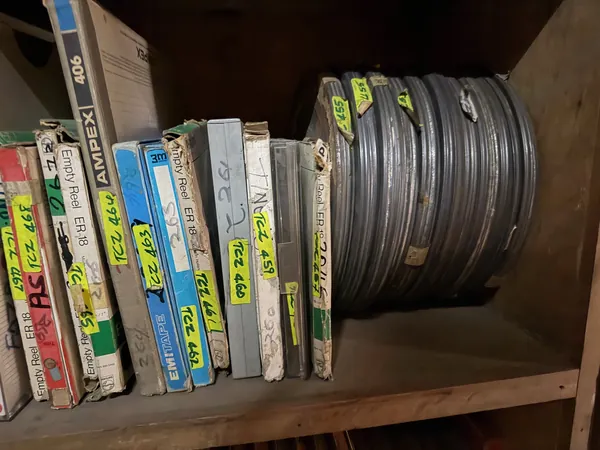 Boxed reels and a loose coil of tape on the shelf.